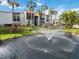 Condo building exterior with palm trees, a pond, and a central fountain at 3255 Beneva Rd # 103, Sarasota, FL 34232