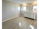 Bright bedroom with wood-look floors and a white dresser at 3334 Overcup Oak Ter, Sarasota, FL 34237