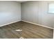 Simple bedroom with wood-look floors and a window at 3334 Overcup Oak Ter, Sarasota, FL 34237