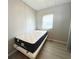 Small bedroom with adjustable bed and window at 3334 Overcup Oak Ter, Sarasota, FL 34237
