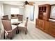 Bright dining area with a glass table and wood hutch at 3334 Overcup Oak Ter, Sarasota, FL 34237