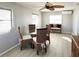 Dining area with glass table, wicker chairs, and a ceiling fan at 3334 Overcup Oak Ter, Sarasota, FL 34237