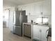 Bright kitchen with stainless steel appliances and white shaker cabinets at 3334 Overcup Oak Ter, Sarasota, FL 34237