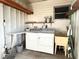 Laundry room with washer, dryer, and shelving at 3334 Overcup Oak Ter, Sarasota, FL 34237