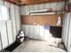 Small workshop with pegboard, paint cans and storage at 3334 Overcup Oak Ter, Sarasota, FL 34237