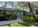 Charming home featuring lush landscaping, a brick walkway, and a serene, inviting entrance at 3350 Old Oak Dr, Sarasota, FL 34239