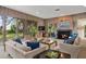 Spacious living room with wood paneling, fireplace, and large windows overlooking the yard at 3350 Old Oak Dr, Sarasota, FL 34239