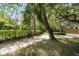 Scenic pathway winding through lush greenery and mature trees, leading to a tranquil and private setting at 3350 Old Oak Dr, Sarasota, FL 34239
