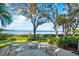 Inviting patio area overlooking lush greenery and waterfront views, perfect for outdoor relaxation and entertaining at 3350 Old Oak Dr, Sarasota, FL 34239