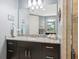 Bathroom with dark vanity, granite countertop, and a walk-in shower at 3450 77Th W St # 102, Bradenton, FL 34209