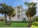 Attractive building exterior with palm trees and lush landscaping at 3450 77Th W St # 102, Bradenton, FL 34209