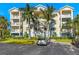 Condo building exterior with palm trees and parking at 3450 77Th W St # 102, Bradenton, FL 34209