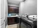 Laundry room with dark cabinets, granite countertop, and washer/dryer at 3450 77Th W St # 102, Bradenton, FL 34209