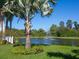 Landscaped pond with fountain, palm trees, and lush greenery at 3450 77Th W St # 102, Bradenton, FL 34209