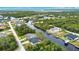 Aerial view of a waterfront community with navigable canals leading to open water at 3479 Knox Ter, Port Charlotte, FL 33948