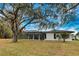 Exterior view of the home's backyard and covered pool area at 3479 Knox Ter, Port Charlotte, FL 33948