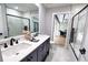 Modern bathroom with double vanity, glass shower, and access to the outdoor patio at 3479 Knox Ter, Port Charlotte, FL 33948