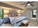 Spacious bedroom with light wood floors, a light blue bed frame, and ensuite bathroom at 3479 Knox Ter, Port Charlotte, FL 33948