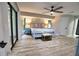 Bright bedroom with light wood floors, a light blue bed frame, and ceiling fan at 3479 Knox Ter, Port Charlotte, FL 33948