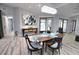 Modern dining room with wooden table and chandelier at 3479 Knox Ter, Port Charlotte, FL 33948