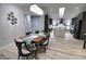 Modern dining room with wooden table and view into kitchen at 3479 Knox Ter, Port Charlotte, FL 33948
