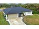 Front exterior view of a one-story home with a two-car garage and driveway at 3479 Knox Ter, Port Charlotte, FL 33948