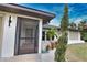 Modern front entrance with a screen door and updated landscaping at 3479 Knox Ter, Port Charlotte, FL 33948