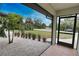 Screened porch with tiled flooring, overlooking a well-landscaped yard at 3479 Knox Ter, Port Charlotte, FL 33948