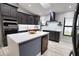 Modern kitchen with island, stainless steel appliances, and dark cabinets at 3479 Knox Ter, Port Charlotte, FL 33948