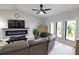 Living room with sectional sofa, fireplace, and large windows at 3479 Knox Ter, Port Charlotte, FL 33948