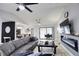 Open living room with a modern electric fireplace, comfortable seating and sliding glass doors at 3479 Knox Ter, Port Charlotte, FL 33948