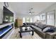 Spacious living area with a modern fireplace, large sectional sofa and wood-look floors at 3479 Knox Ter, Port Charlotte, FL 33948