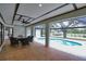 Covered patio with dining area and pool overlooking the water at 3479 Knox Ter, Port Charlotte, FL 33948