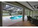 Covered patio overlooks a refreshing pool and canal at 3479 Knox Ter, Port Charlotte, FL 33948