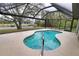 Inviting kidney-shaped pool with a screened enclosure at 3479 Knox Ter, Port Charlotte, FL 33948