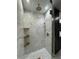 Elegant shower with marble tile and gold fixtures at 3479 Knox Ter, Port Charlotte, FL 33948
