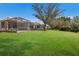 Landscaped backyard with large green lawn area at 3614 Summerwind Cir, Bradenton, FL 34209