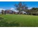 Spacious backyard featuring a large grassy area and home at 3614 Summerwind Cir, Bradenton, FL 34209