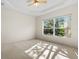 Bedroom with ceiling fan and view of large tree through window at 3614 Summerwind Cir, Bradenton, FL 34209