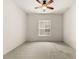 Spacious bedroom with ceiling fan and carpeted floor at 3614 Summerwind Cir, Bradenton, FL 34209