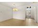 Spacious dining area with tile floors and a chandelier at 3614 Summerwind Cir, Bradenton, FL 34209