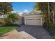 Tan house with a three-car garage and a brick driveway at 3614 Summerwind Cir, Bradenton, FL 34209