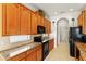 Kitchen with wood cabinets, granite countertops and black appliances at 3614 Summerwind Cir, Bradenton, FL 34209