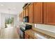 Bright kitchen features granite counters, wood cabinets, and view to backyard at 3614 Summerwind Cir, Bradenton, FL 34209