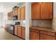 Kitchen with granite countertops, wood cabinets, and black appliances at 3614 Summerwind Cir, Bradenton, FL 34209