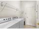 Bright laundry room with washer, dryer, and ample shelving at 3614 Summerwind Cir, Bradenton, FL 34209