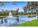 Scenic pond with a water fountain and lush greenery at 3614 Summerwind Cir, Bradenton, FL 34209