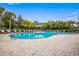Community pool with lounge chairs and lush landscaping at 3614 Summerwind Cir, Bradenton, FL 34209