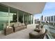 Relaxing balcony boasting city and water views, wicker furniture, and ample space at 401 Quay Commons # 901, Sarasota, FL 34236