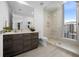 Modern bathroom with walk-in shower and city views at 401 Quay Commons # 901, Sarasota, FL 34236